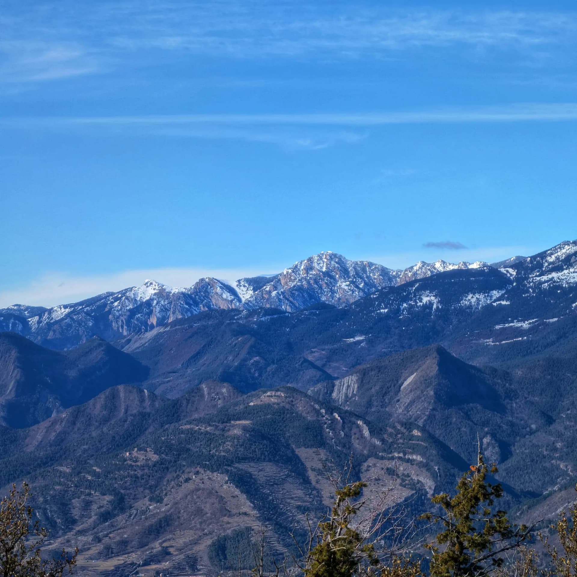 Panoramic view from Pedró de Tubau summit, showing snow-capped Moixeró and Penyes Altes del Moixeró.