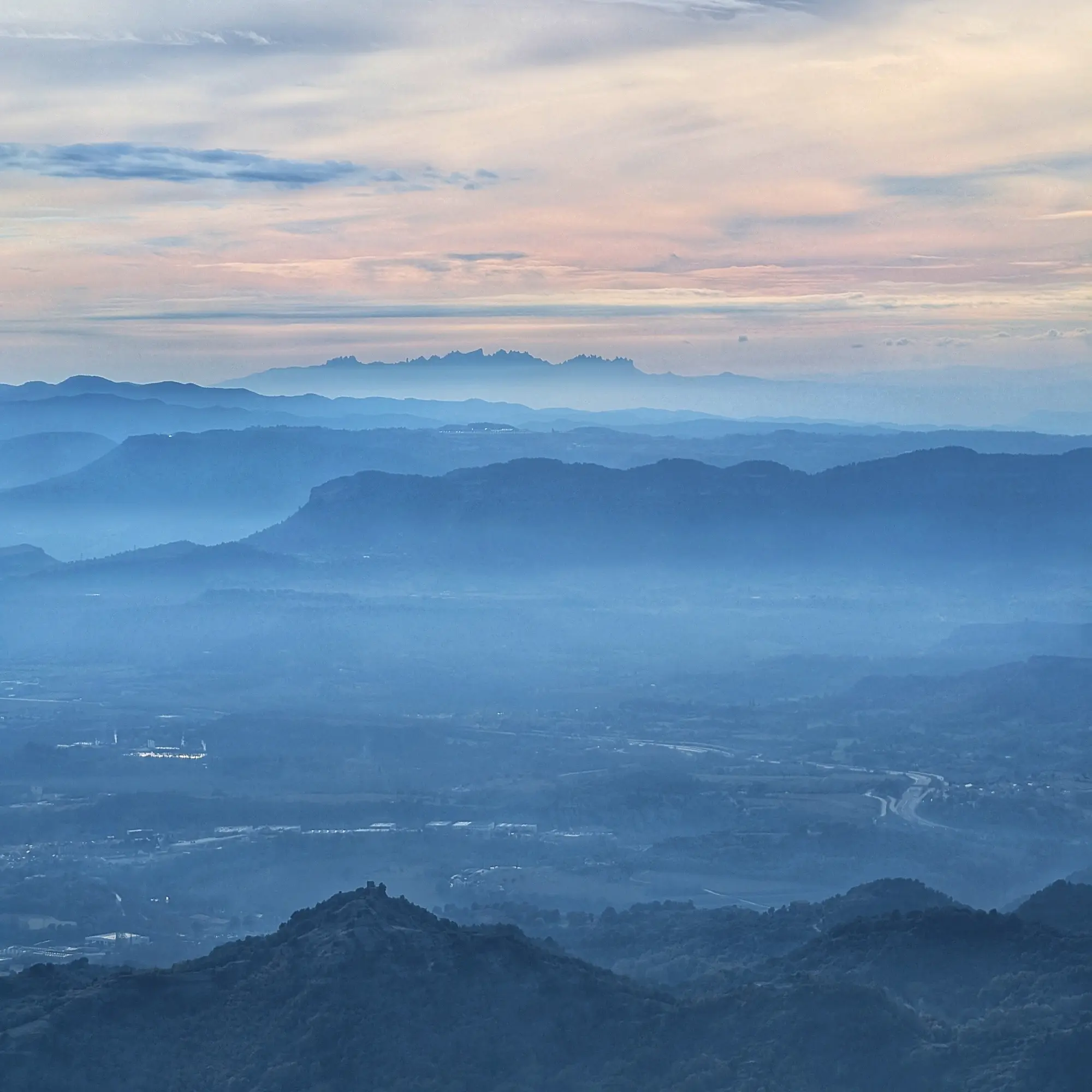 Bellmunt view: Torello Castle foreground, Voltregà Castle center, Sant Llorenç del Munt left, Montserrat mountains background.