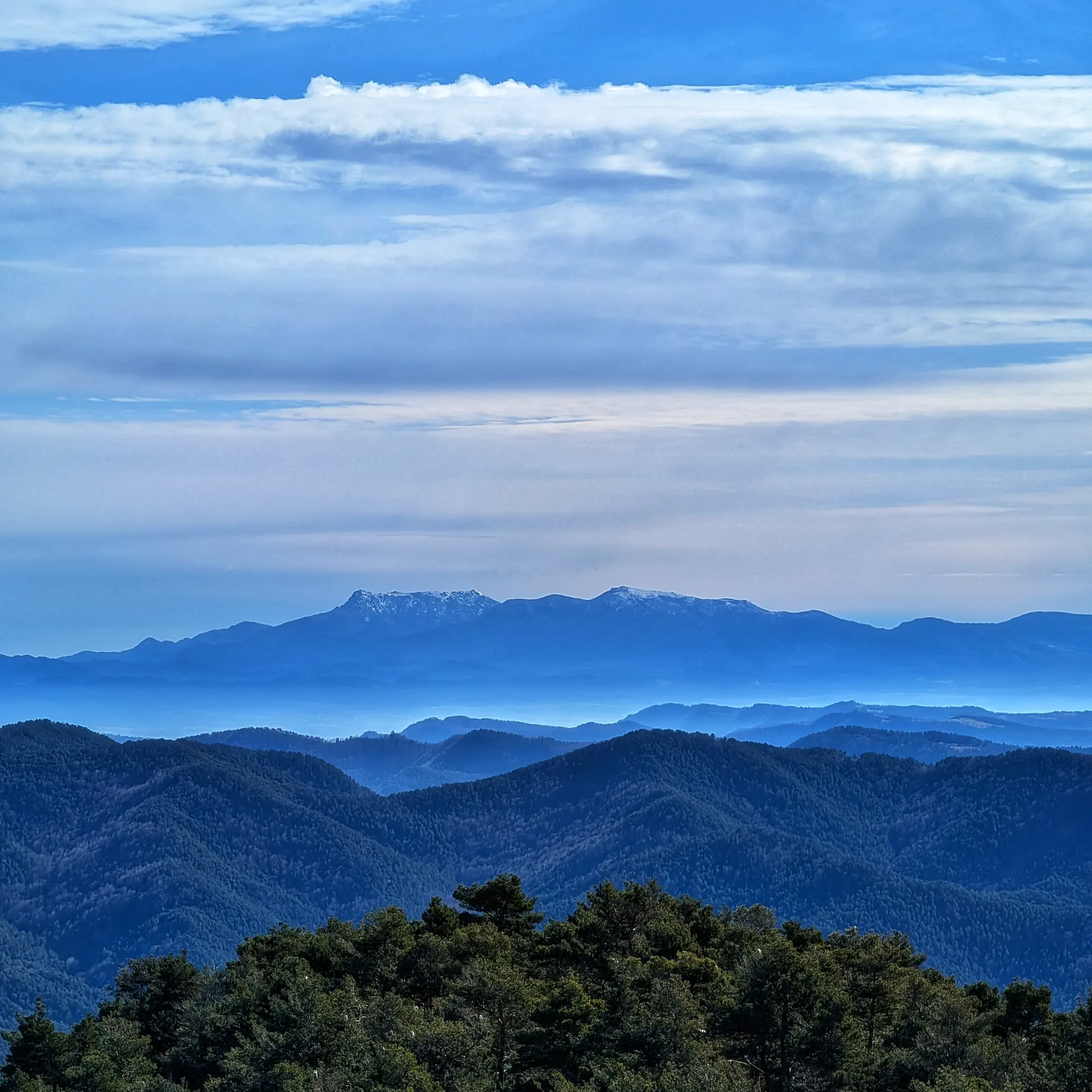 Montseny massif with Les Agudes and Turó de l'Home peaks (left) and Matagalls (right), all slightly snow-covered.