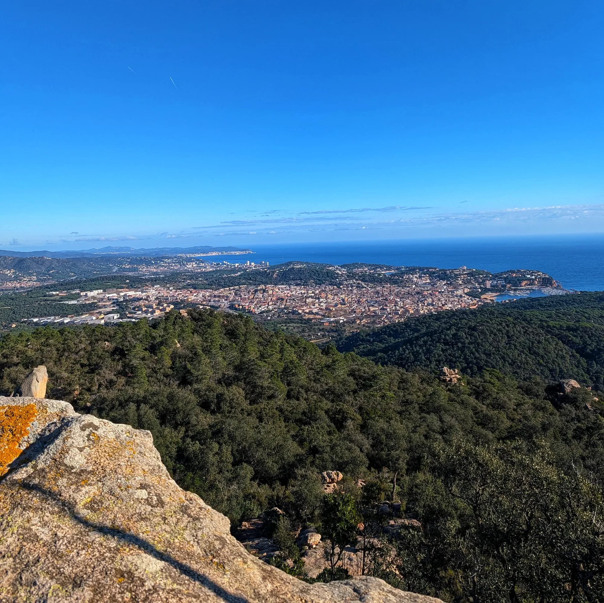 Panoràmica de Sant Feliu de Guíxols amb costa, edificis i port des del Puig Gros.